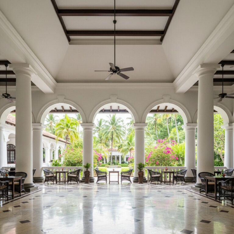 Elegant colonial heritage hotel veranda with arches, pillars, and tropical garden views.