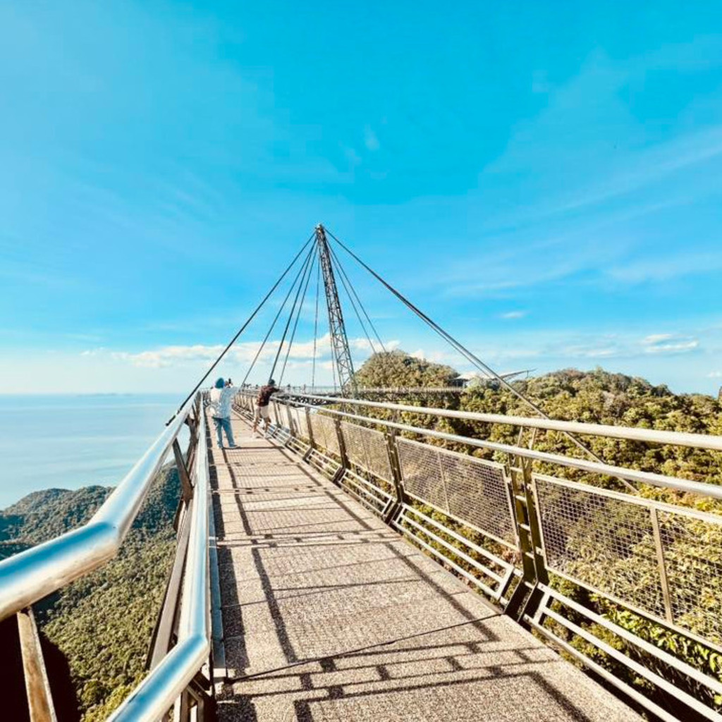 Langkawi Eagle Square statue with "LANGKAWI" sign against a blue sky