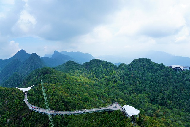 Langkawi Sky Bridge view amidst lush mountains, a highlight of heritage travel.