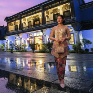 Woman in traditional dress at The Blue Mansion Penang, a heritage building.