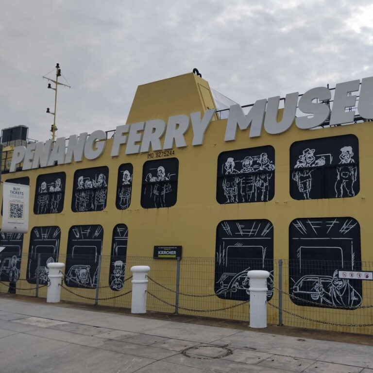 Penang Ferry Museum exterior with illustrations of passengers and vehicles.