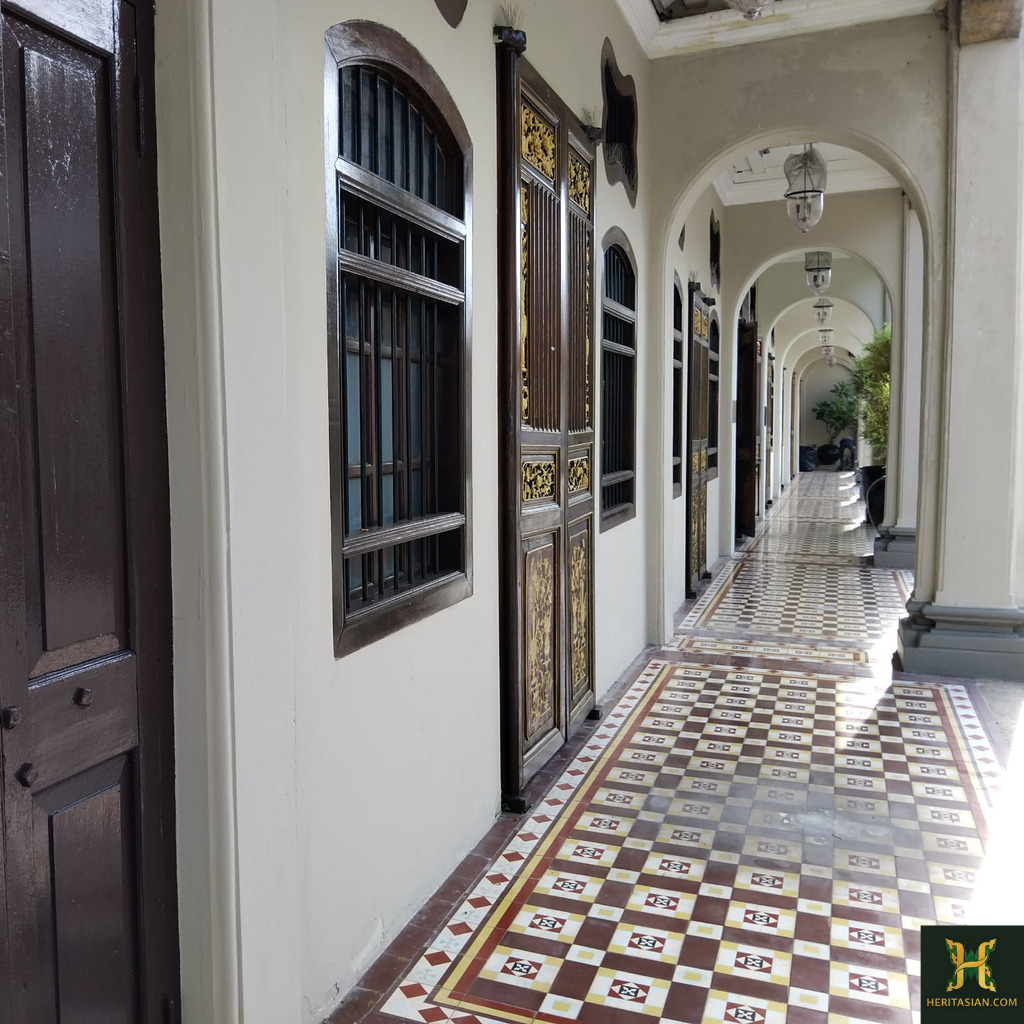 Seven Terraces Georgetown corridor with tile flooring and arched walkways.