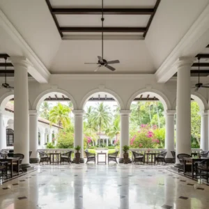 Elegant hotel lobby with arched colonnade and tropical garden view